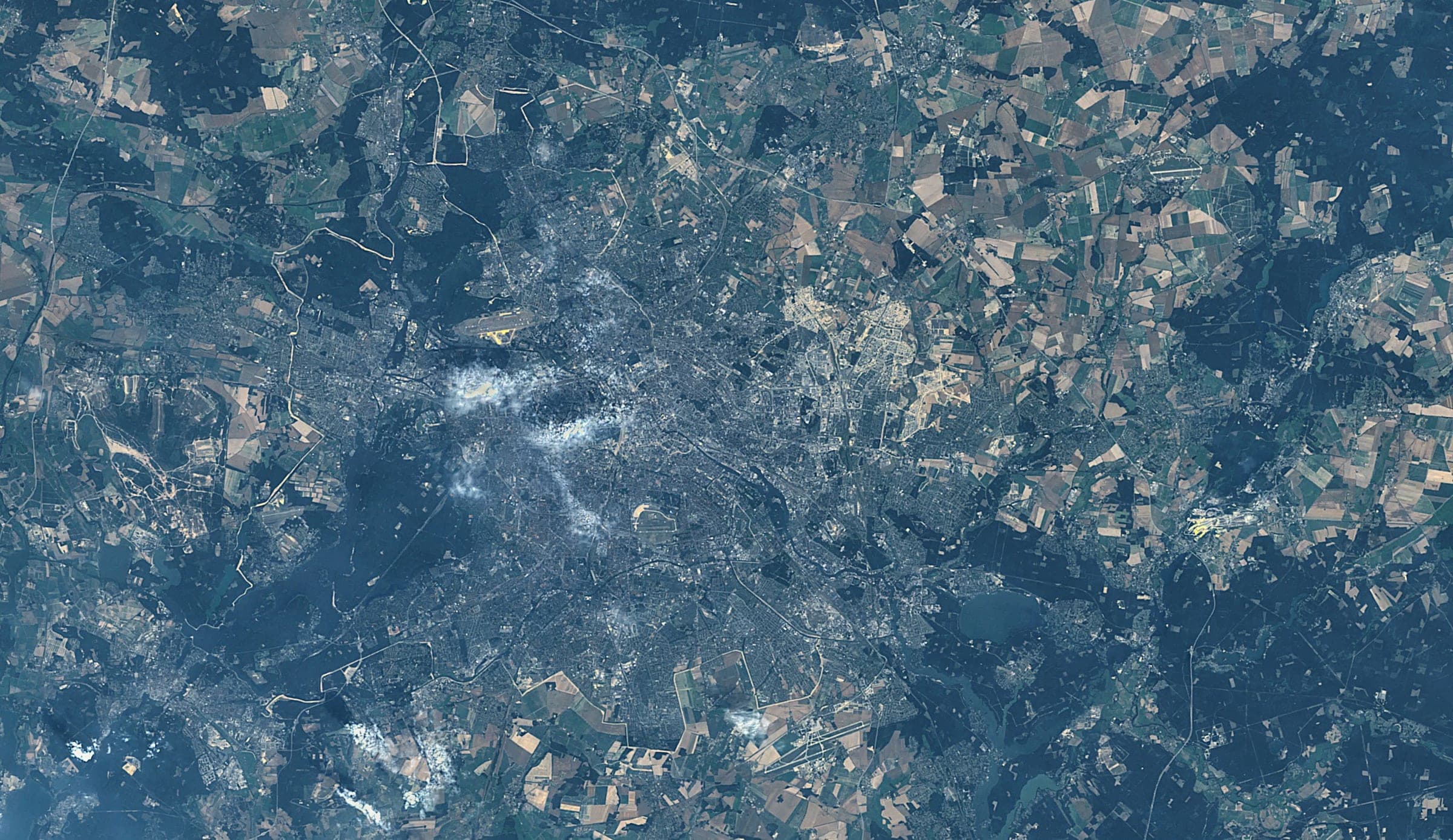 Berlin sits in a ring of lakes and pine forest, the Havel widening to the west and the Spree threading through the centre. Landsat frame, 30 metres per pixel.